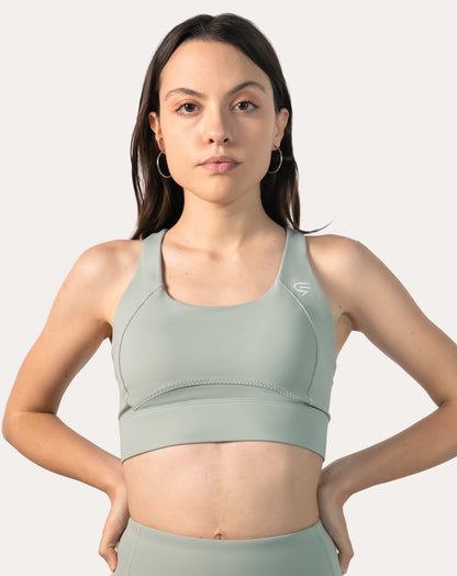 Straight front view of the sage green running sports bra with wide underband