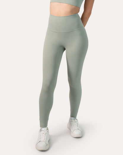 Close-up of sage green gym set leggings, front waistband and sculpting high-rise fit