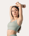 Close-up of V-neck bra on the sage green gym set, front detail of the longline top