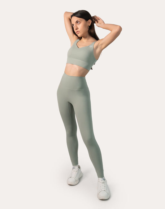 Front view of sage green gym set with V-neck clasp-back bra and high-rise leggings