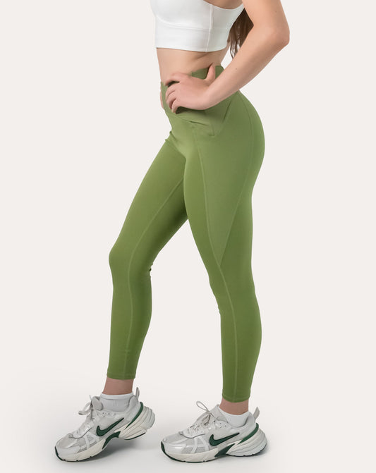 Sage green yoga leggings with V-shaped high waist; left three quarter view