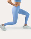 Light blue seamless gym leggings with V-contour high waistband; side lunge profile