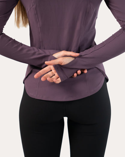 Back view of slate-lavender women’s training jacket showing streamlined seams and fitted hood