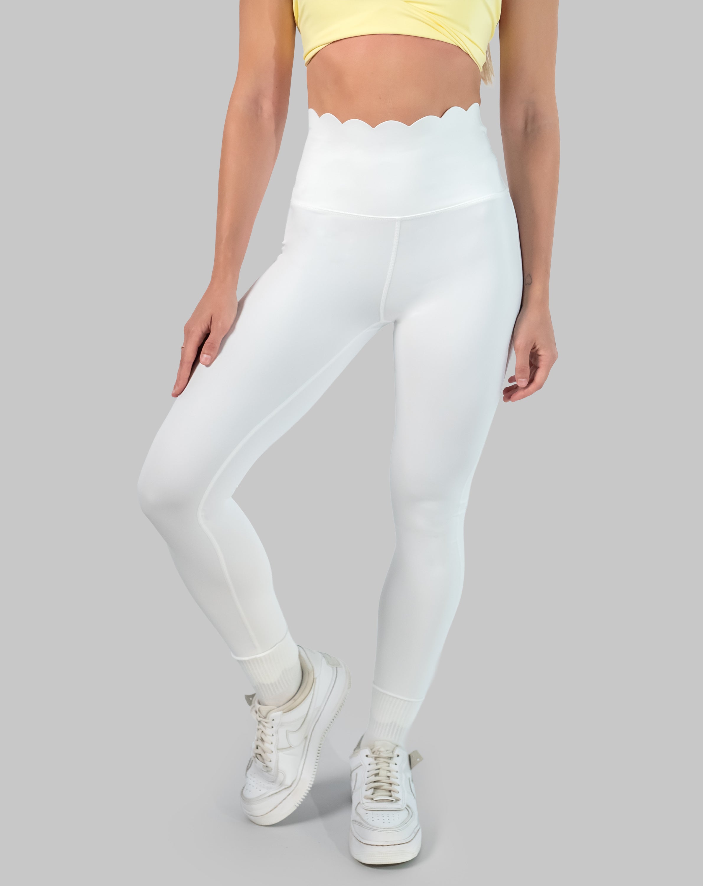 Non see through white leggings with scallop high waisted band, ankle length; front three quarter view