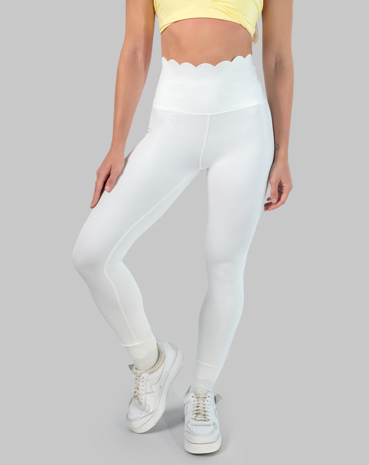 Non see through white leggings with scallop high waisted band, ankle length; front three quarter view