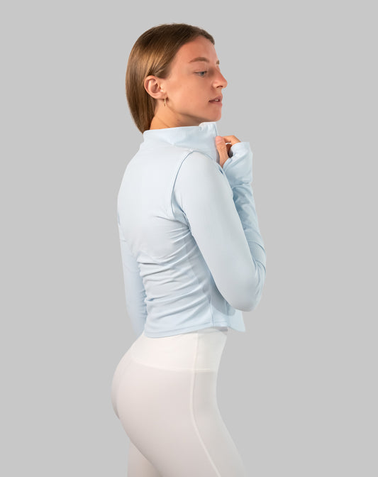 Powder-blue track jacket women, left side view with stand collar zipped up