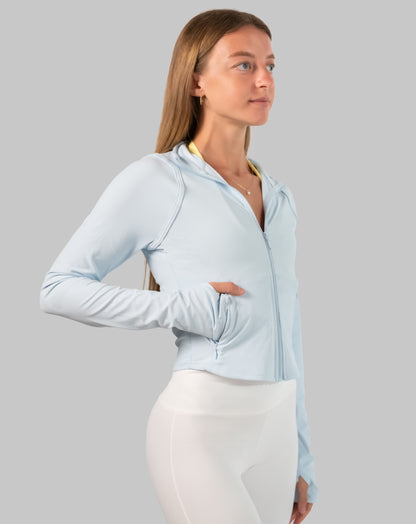 Right three-quarter view of powder-blue track jacket women highlighting ribbed knit