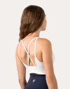 Close-up of the back on white backless sports bra showing crisscross straps and open back