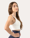 White backless sports bra, three-quarter front view showing smooth V-neck and longline band
