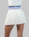 Back close-up of white golf skirt showing striped high-waist band and pleated hem