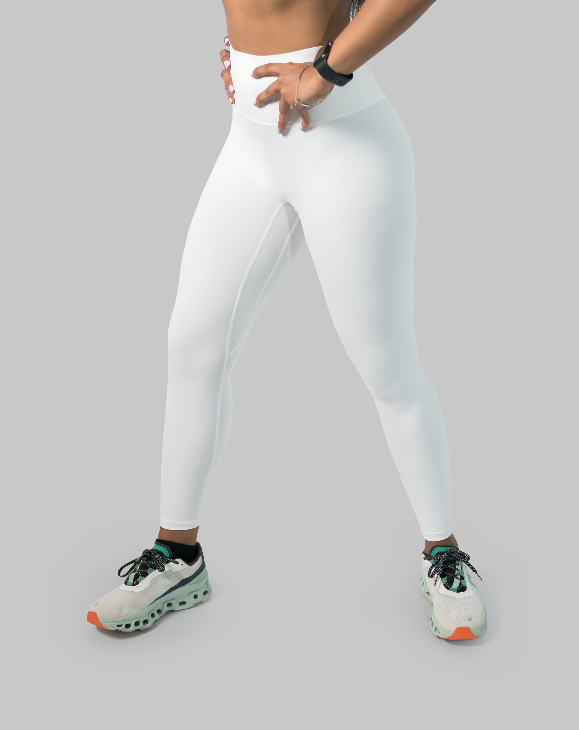 White gym leggings with high waist, ankle length; left three quarter view in a step stance