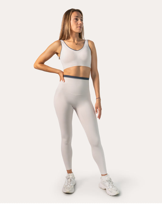 Front view of white gym set for women with contrast-trim bra and high-waist leggings