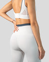 Close-up of white gym set for women leggings showing back waistband and minimal seams
