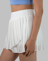 Side close-up of white pleated wrap gym skirt highlighting supportive waistband
