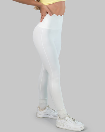 White leggings with high waisted scallop waistband, ankle length; left side view