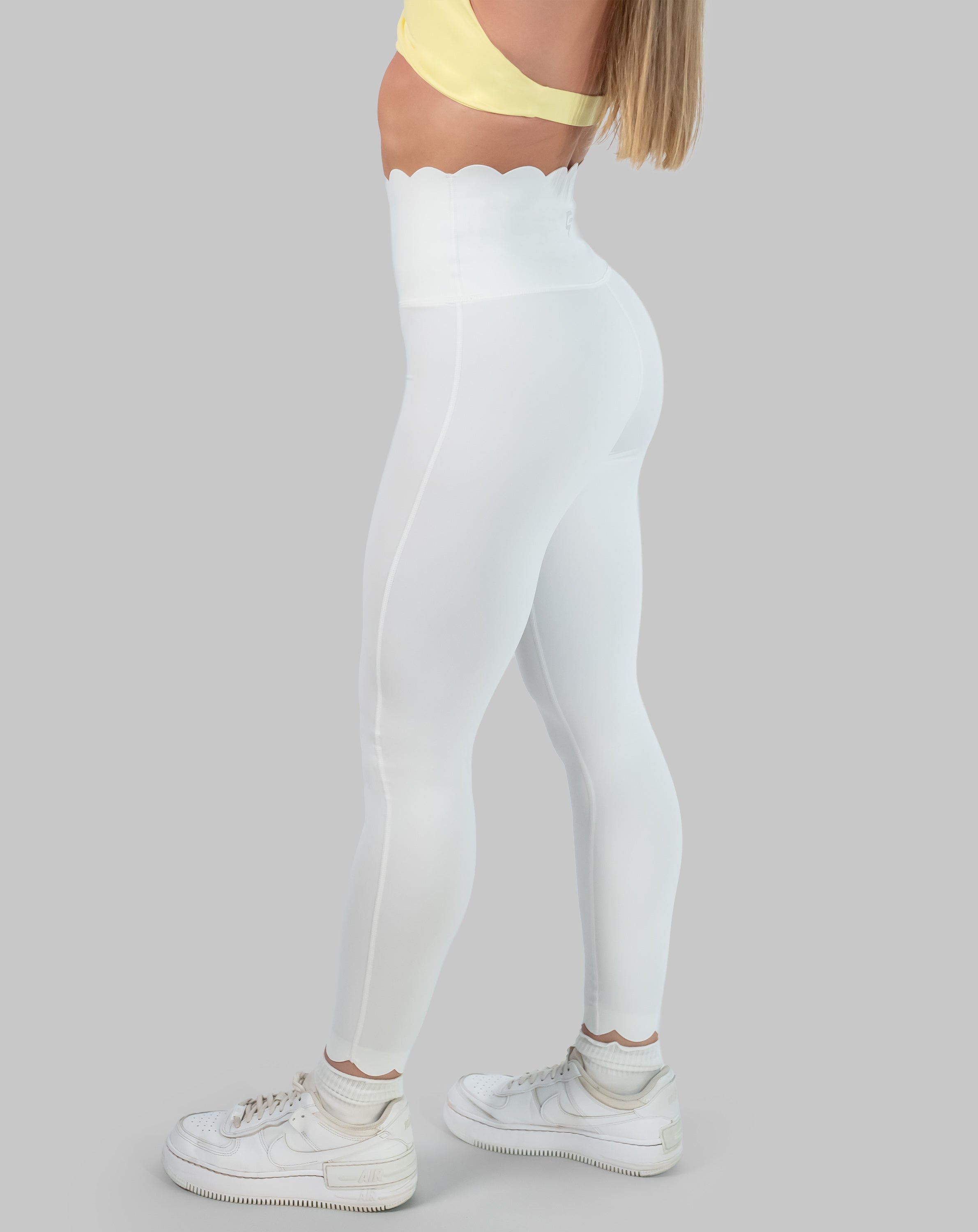 White leggings with high waisted scallop waistband, ankle length; right side view