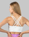 Left back three-quarter view of white medium support sports bra with X-back straps