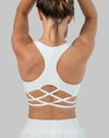 Back close-up of white strappy back sports bra showing lattice cross-back straps