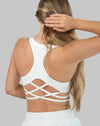 Back three-quarter view of white strappy back sports bra with lattice cross-back detail