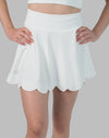 Front close-up of white tennis skirt with scalloped hem and high-rise waistband