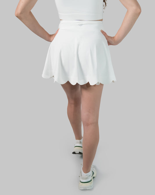 Back view of white tennis skirt with scalloped hem and high-rise waist