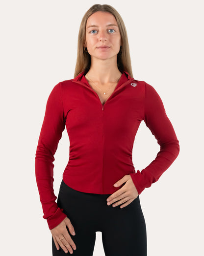 Crimson running jacket for women in a full front view with full zip-up and stand collar