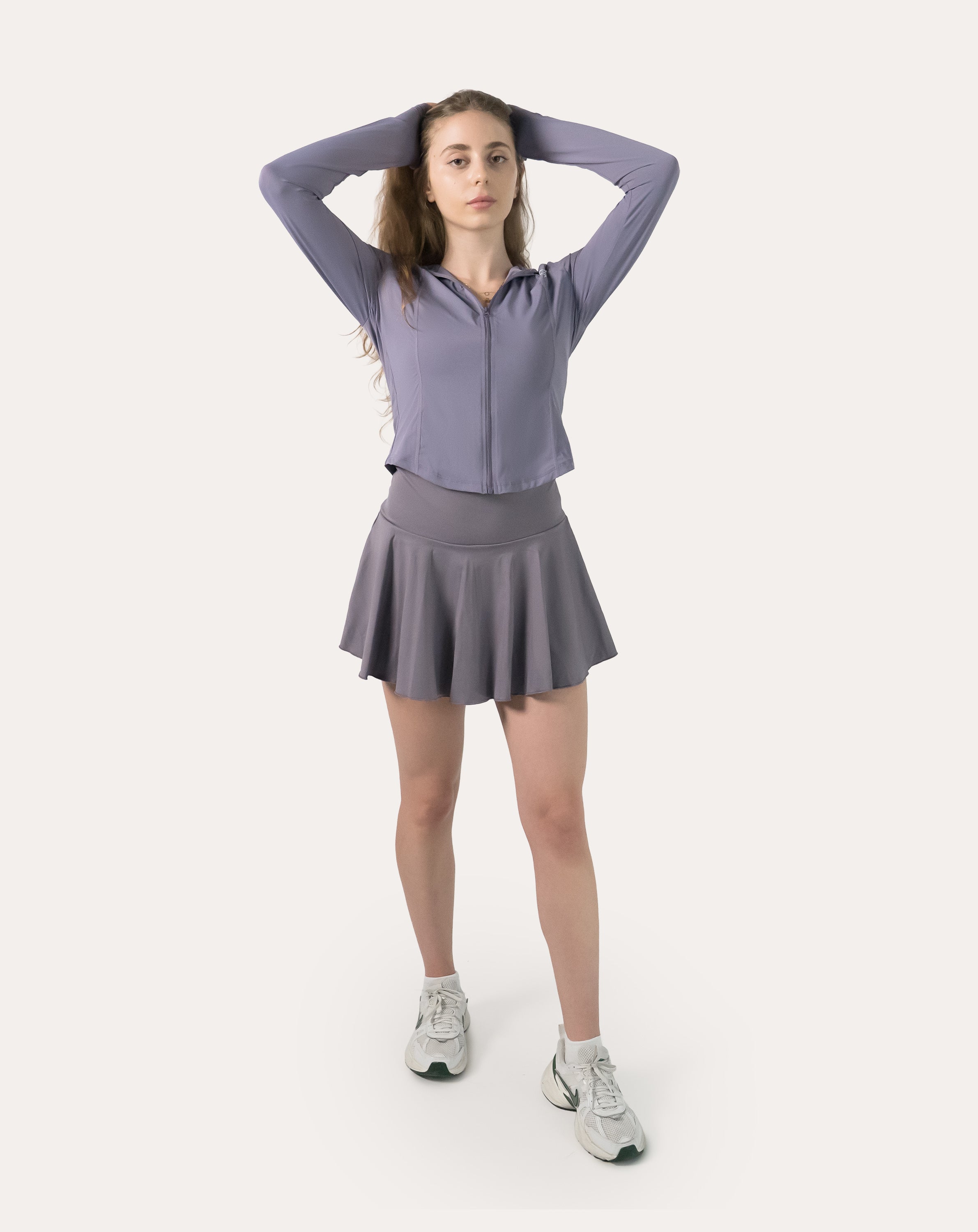 Front view of the lavender women’s fitness jacket with arms raised to show mobility