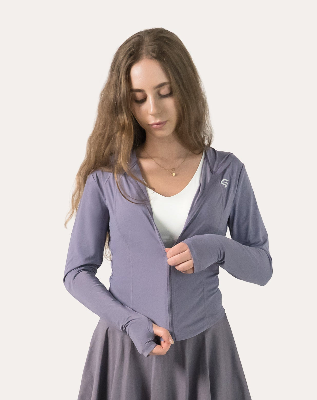 Lavender women’s fitness jacket, front view while adjusting the full zip