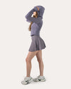 Right three-quarter view of the lavender fitness jacket with arm raised to stretch