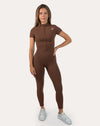 Full front view of the brown women’s gym jumpsuit highlighting the short sleeves