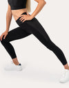 Black womens gym set leggings detail in side lunge showing high-waist fit and smooth seams