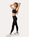 Black womens gym set front view with arms raised; square-neck bra and supportive waistband