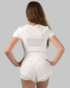 Women's gym set in white, back view with curved split short hems