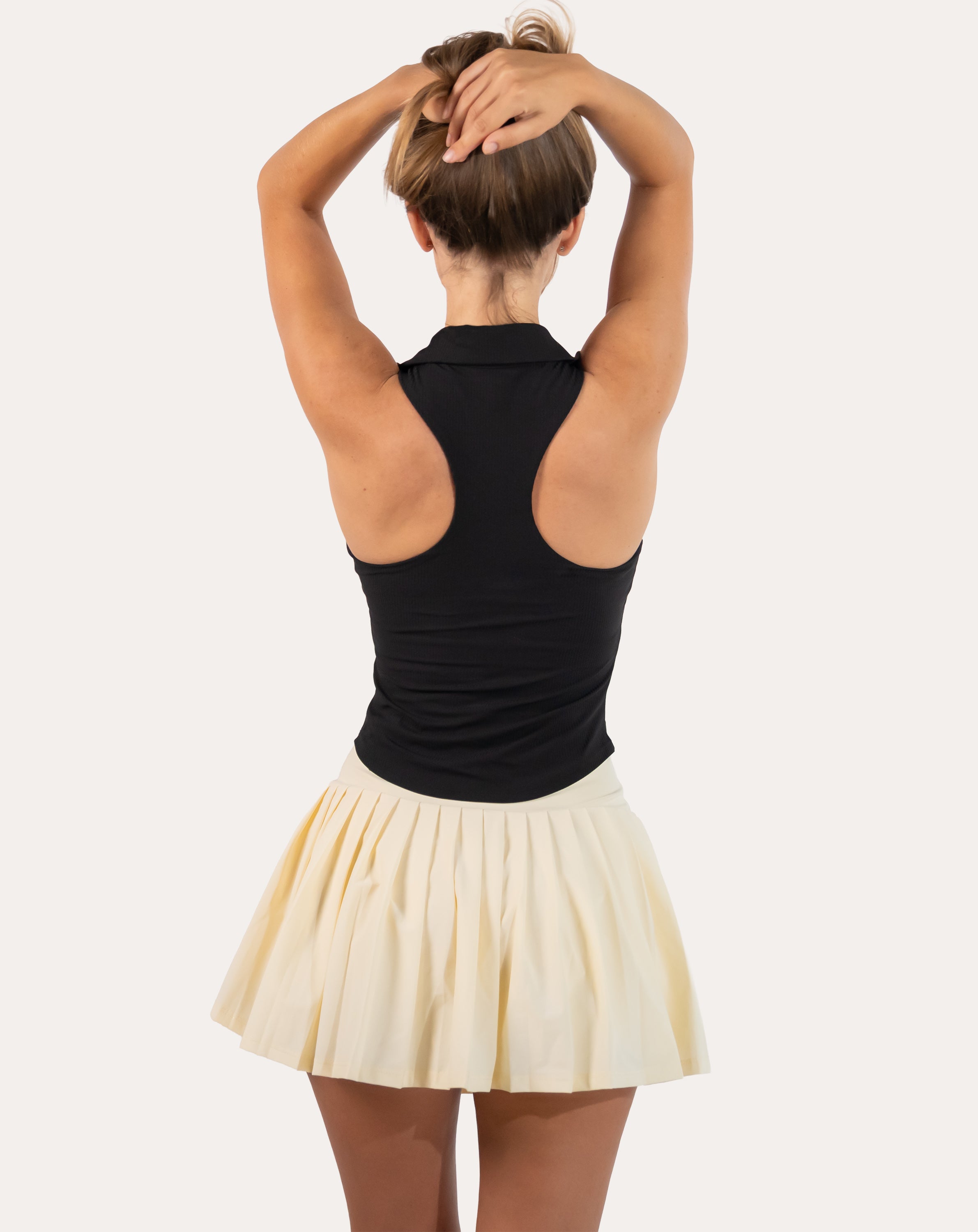 Back view of black womens gym tank top highlighting open racerback