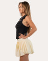 Black womens gym tank top side profile showing ribbed fit and shaped hem