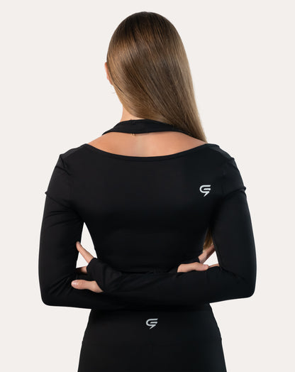 Back view of black long sleeve gym top womens with cropped hem and smooth finish