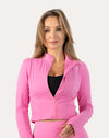 Front waist-up view of the women’s pink cropped zip-up jacket with partially closed zip