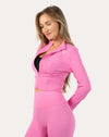 Left three-quarter view of the women’s pink cropped zip-up jacket highlighting the sculpted fit