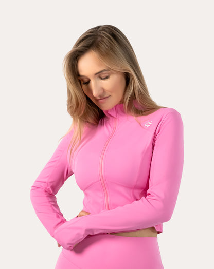 Right three-quarter waist-up view of the women’s pink cropped zip-up jacket with zip and collar detail