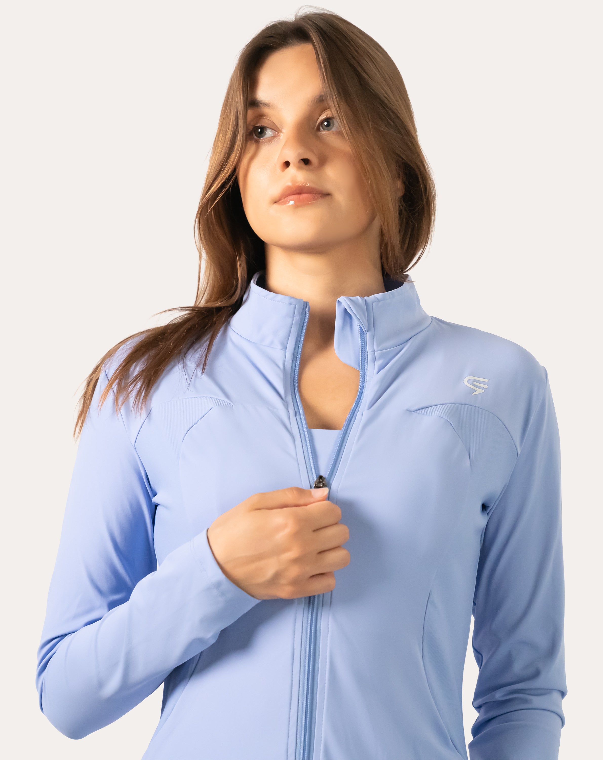 Close-up of the zip and soft stand collar on the powder blue women’s running jacket