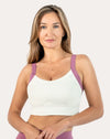 Front view of white/lilac women’s sports bra with wide straps and smooth scoop neck