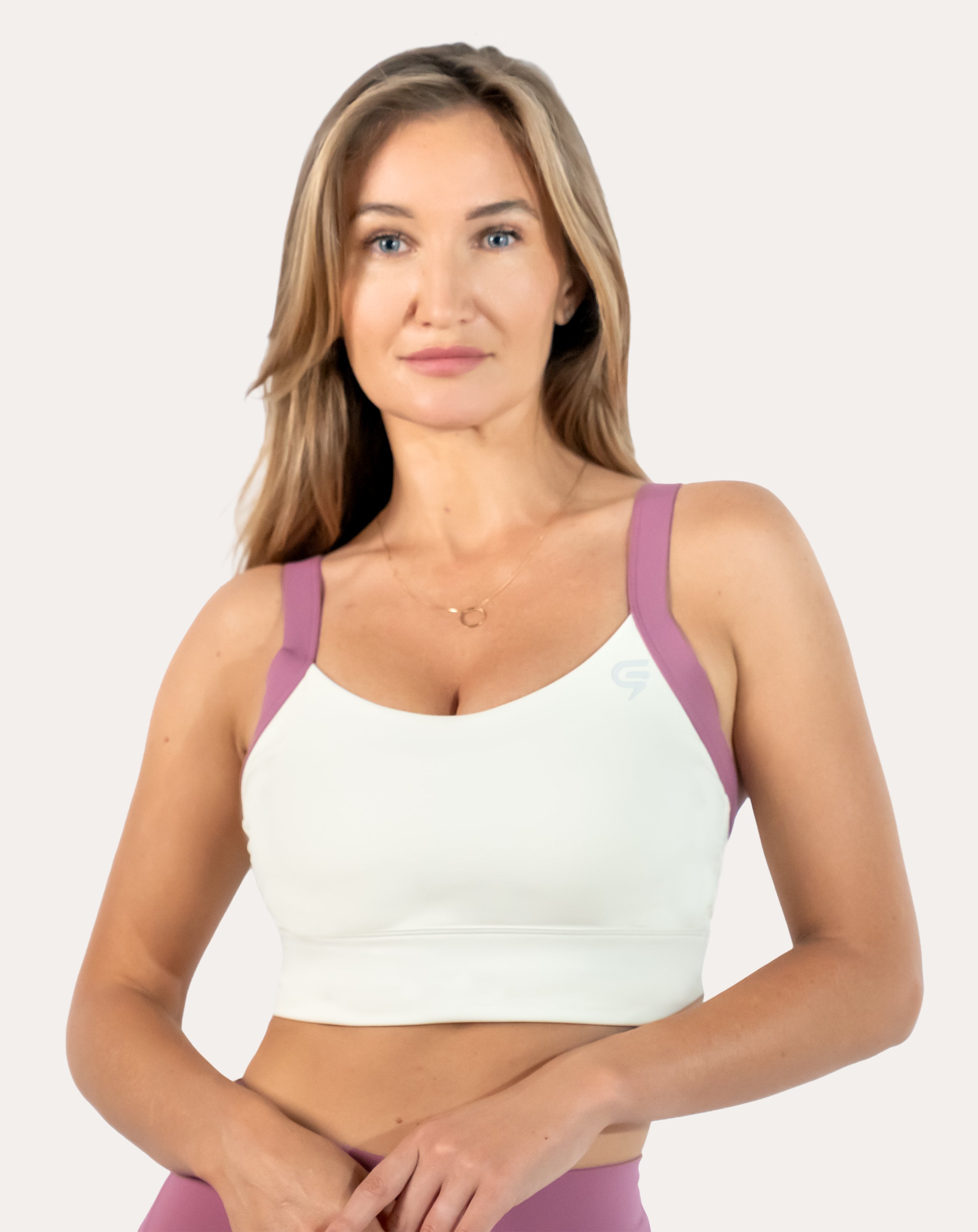 Front view of white/lilac women’s sports bra with wide straps and smooth scoop neck