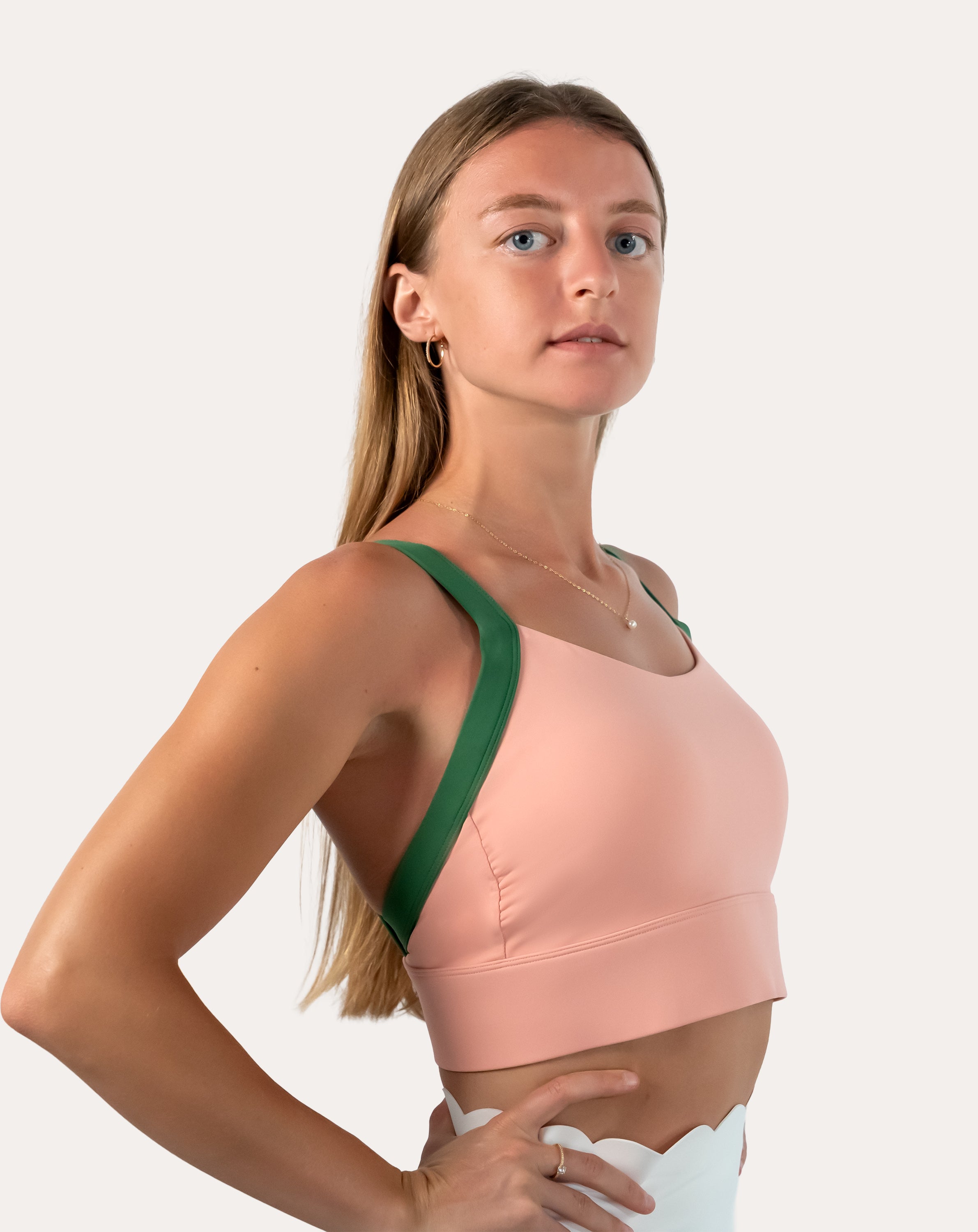 Peach/green yoga sports bra in three-quarter front view showing scoop front and supportive band